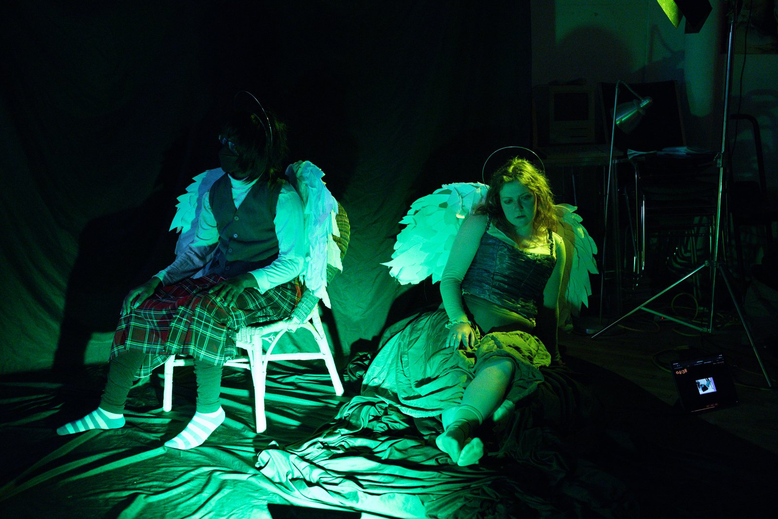 Lost Angels, two angels in green and gold light