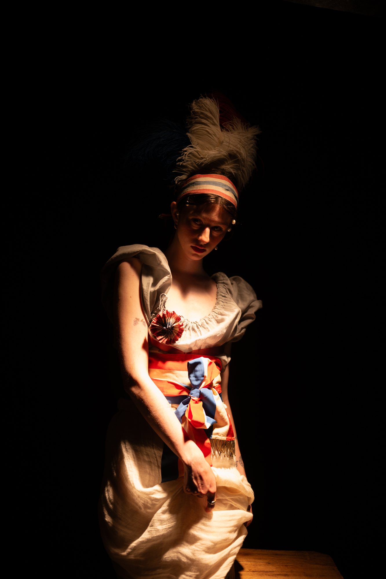 French Revolution photoshoot, model with a feathered tricolour headband