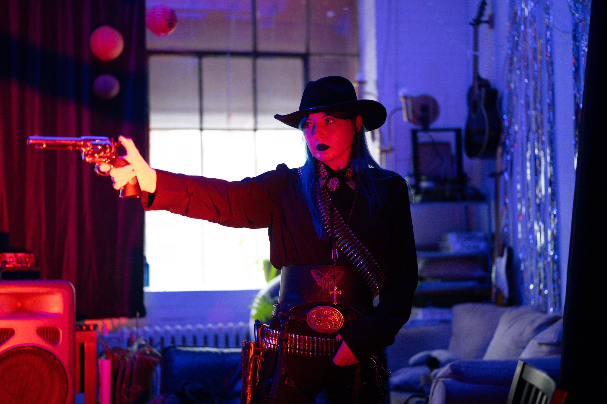 Gothic Country, model aiming a revolver across the room