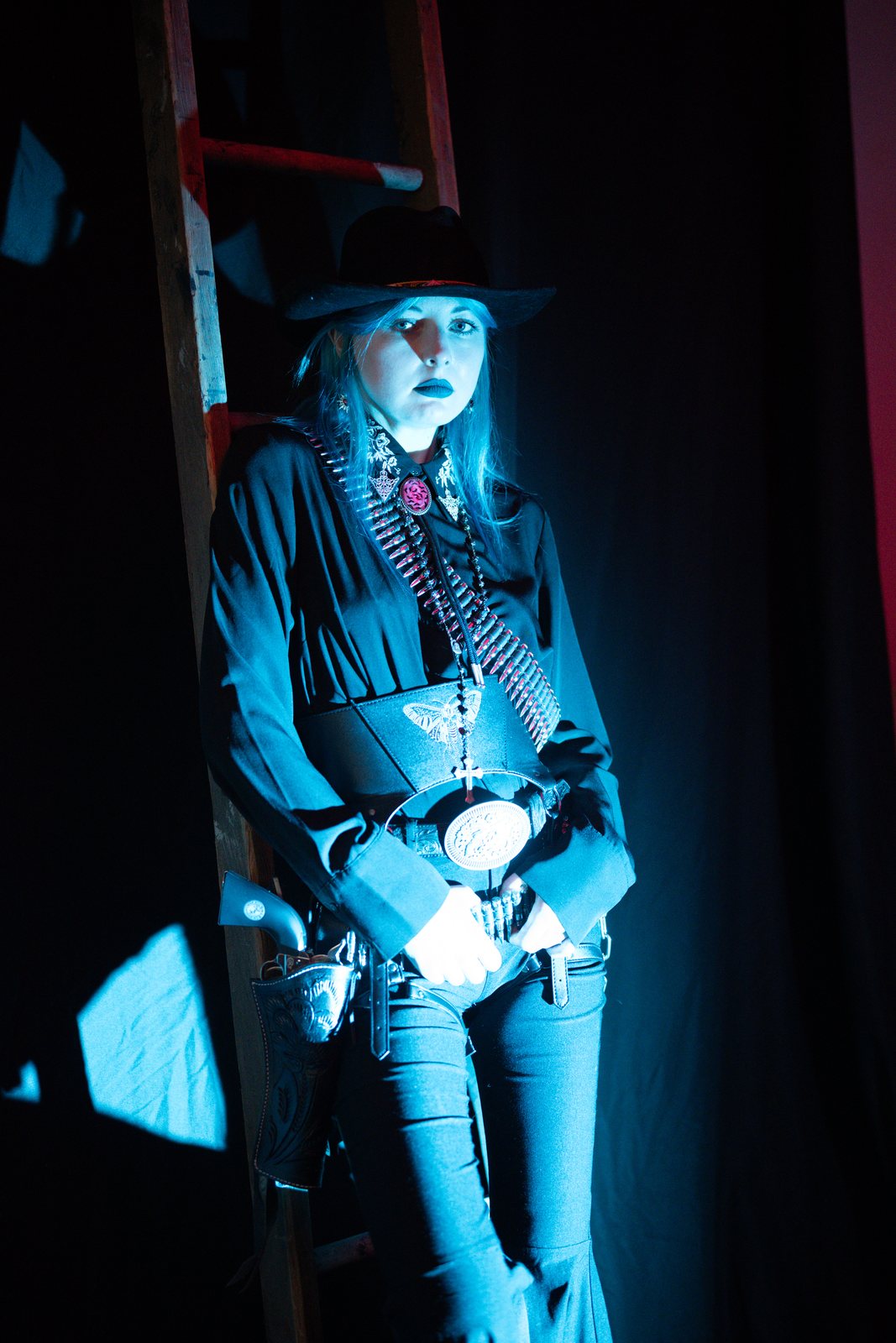 Gothic Country, model leaning on a ladder in blue light