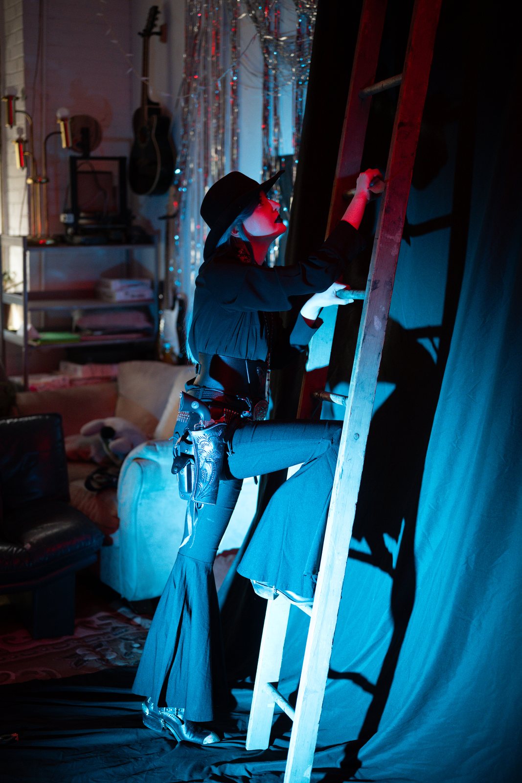 Gothic Country, model climbing a ladder in red and blue light